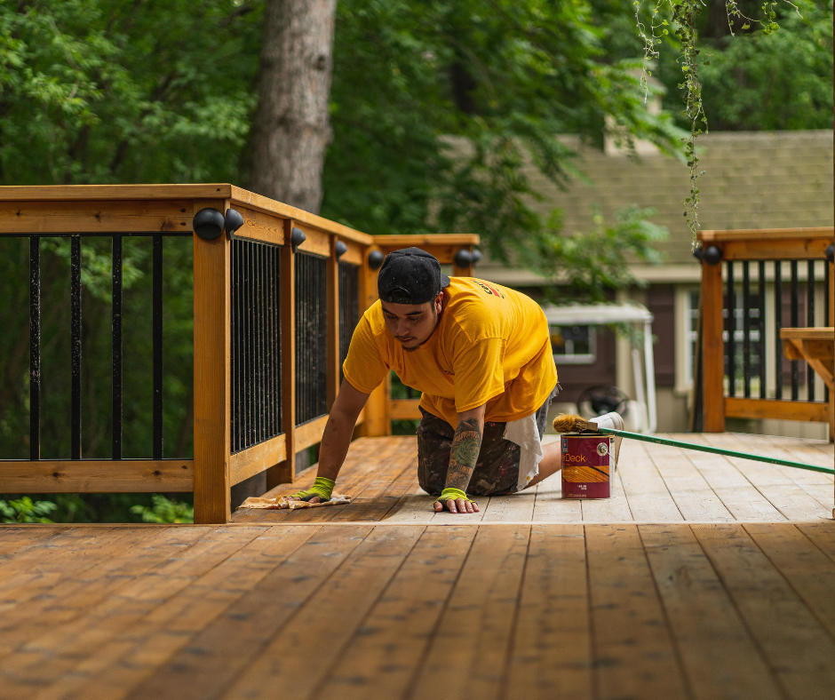 certapro painter staining a deck