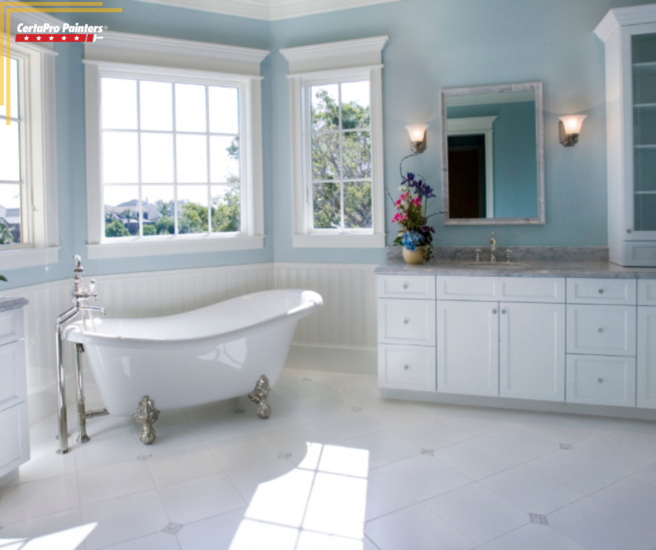 blue bathroom with white cabinets