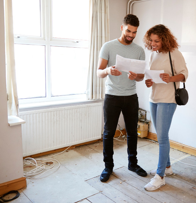 man and woman assessing wood floor in historic home