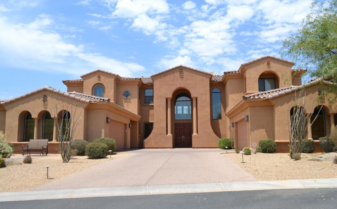 professional painting stucco exterior on shingled house
